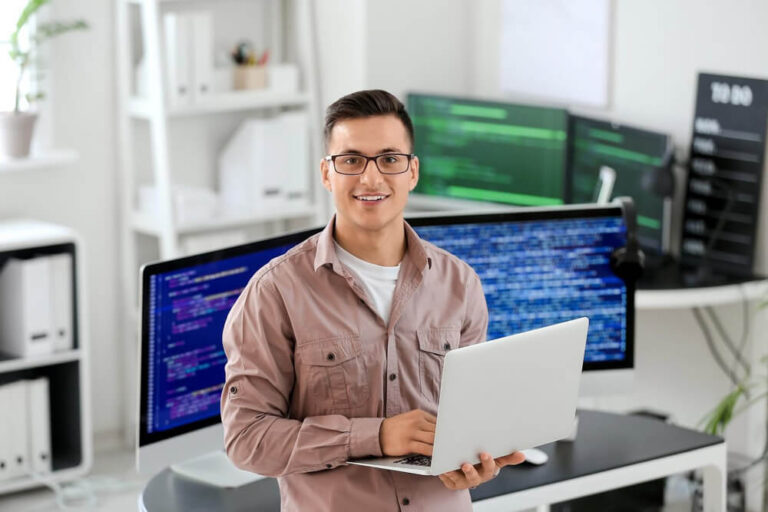 Young man in office with laptop